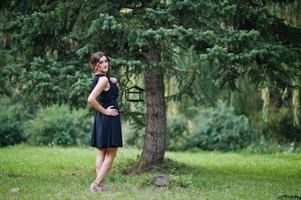 Portrait of gorgeous girl wear on black at hen party, posed at park. photo