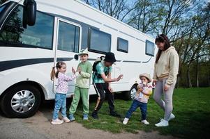 Mother with four children travel at motorhome RV camper van. photo