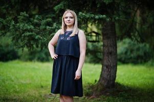 Portrait of gorgeous girl wear on black at hen party, posed at park. photo