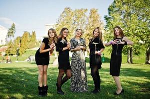 Five girls wear on black having fun at hen party. photo