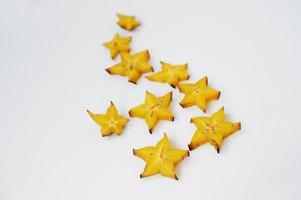 Close-up photo of star fruit or carambola slices on the white background.