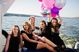 Girls having fun at yacht on hen party. photo