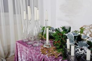 Table with candles and decor. Happy winter holidays concept. photo