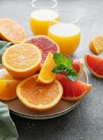 Glasses of juice and citrus fruits photo