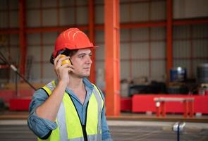 Chief mechanical engineer working in a mechanical factory Controlling machine testing in the factory photo