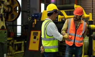 Engineering team leader Is advising the technician team and the quality inspection team. photo
