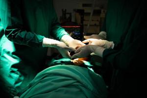 The doctor in operating room undergoing surgery to replace a patient's heart photo