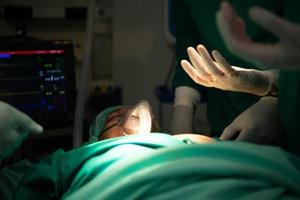 Professor of medicine in cardiology and a team of doctors in the operating room undergoing heart transplant surgery photo