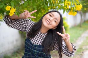 Portrait young girl with yellow flowers, Asian girl. photo