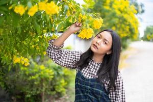 Portrait young girl with yellow flowers, Asian girl. photo