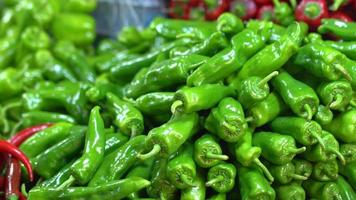 Red and green peppers. Red and green chillies available on the counter. video