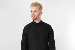 portrait handsome man in black shirt on white background looking away photo