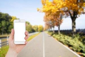 hand using navigation app on the mobile phone, mock up,blank screen mobilephone, travel concept photo