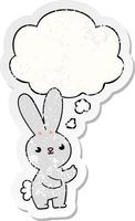 cute cartoon rabbit and thought bubble as a distressed worn sticker vector