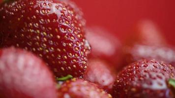 Close-up of ripe juicy strawberries with drop of water flowing over the surface