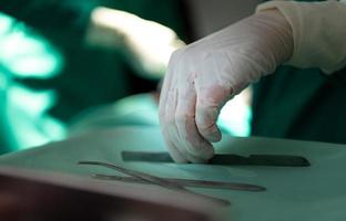 Professor of medicine in cardiology and a team of doctors in the operating room undergoing heart transplant surgery photo