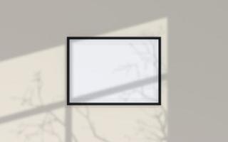 Clean and minimalist front view landscape black photo or poster frame mockup hanging on the wall with shadow overlay. 3d rendering.