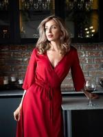 Beautiful adult woman standing in the kitchen photo