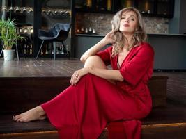 Beautiful adult woman sitting in the kitchen photo