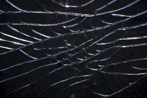 Broken glass over natural black background. photo