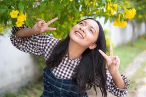 Portrait young girl with yellow flowers, Asian girl. photo