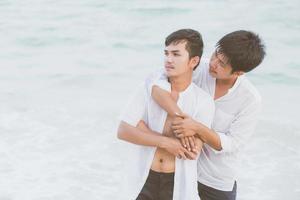 Homosexual portrait young asian couple standing problem on beach in summer, asia gay angry and unhappy in vacation at sea, relationship with disappointed and frustrated, LGBT with legal concept. photo