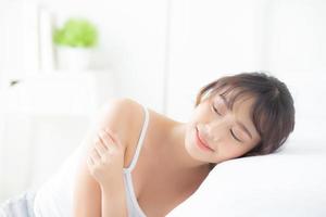 Young asian woman applying cream and treatment for skin care touch on shoulder, asia girl with lotion spa and moisturizing for health and wellness body part, lifestyle and beauty cosmetic concept. photo