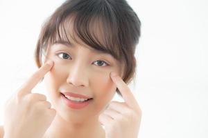 Portrait of beautiful young asian woman smile healthy and wellness at the bedroom, beauty asia girl skin care touch eye makup and cosmetic with happy with fresh, lifestyle and relax concept. photo