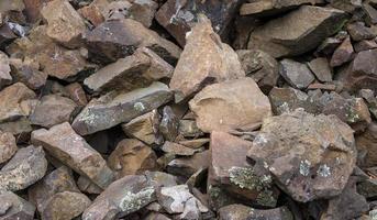 Texture, background of mountain stones covered with moss and small vegetation photo