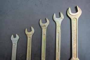 A set of new wrenches made of durable alloy of different calibers for tightening nuts and bolts photo