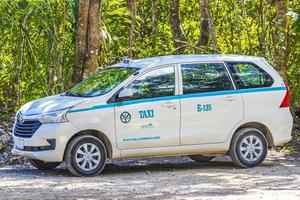 Puerto Aventuras Quintana Roo Mexico 2022 Taxi car in tropical natural jungle Playa del Carmen Mexico. photo