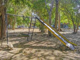 Slide and climbing frame on a playground park in Mexico. photo