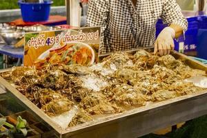 Live crabs lobsters Thai night market street food, Bangkok, Thailand. photo