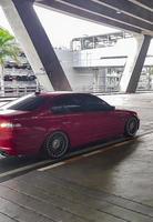 Red parked car at the exit Bangkok Suvarnabhumi Airport Thailand. photo