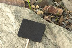 Chalkboard on stone beach background. Copy space. Directly above. photo