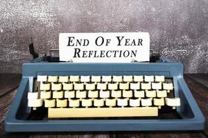 End of year reflection words typed on an old typewriter. New year concept. photo