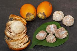 Betel nut or areca nut with betel leaf isolated on dark background. photo
