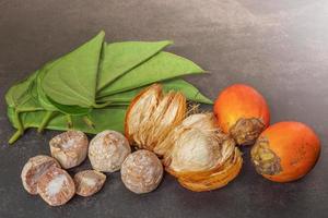 Betel nut or areca nut with betel leaf isolated on dark background. photo