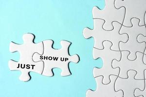 Just show up words on two pieces of white jigsaw puzzle on blue background. photo