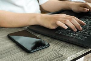 Cropped image of professional business woman working at home office via laptop, manager using portable computer device work process concept photo