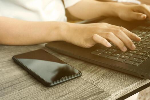 Cropped image of professional business woman working at home office via laptop, manager using portable computer device  work process concept photo