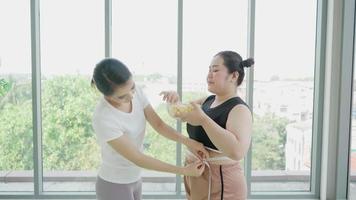 Fitness Trainer Measuring Woman to Make Workouts Plan. video