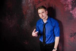 Studio portrait of stylish man, wear on blue shirt and necktie. photo