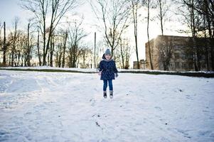 Cute little girl having fun outdoors on winter day. photo