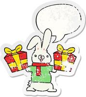 cartoon rabbit and christmas presents and speech bubble distressed sticker vector