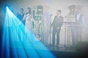 Musicial music live band performing on a stage with different lights. photo