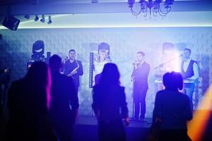 Live band performing with enthusiastic crowd of fans