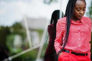 Pretty braids business african american lady bright bossy person friendly wear office red shirt and trousers. photo