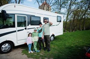 Father with three children travel at motorhome RV camper van. photo