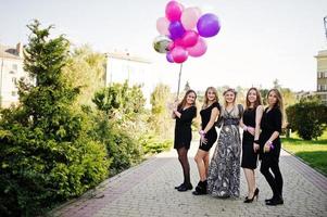 Five girls wear on black with balloons at hen party. photo